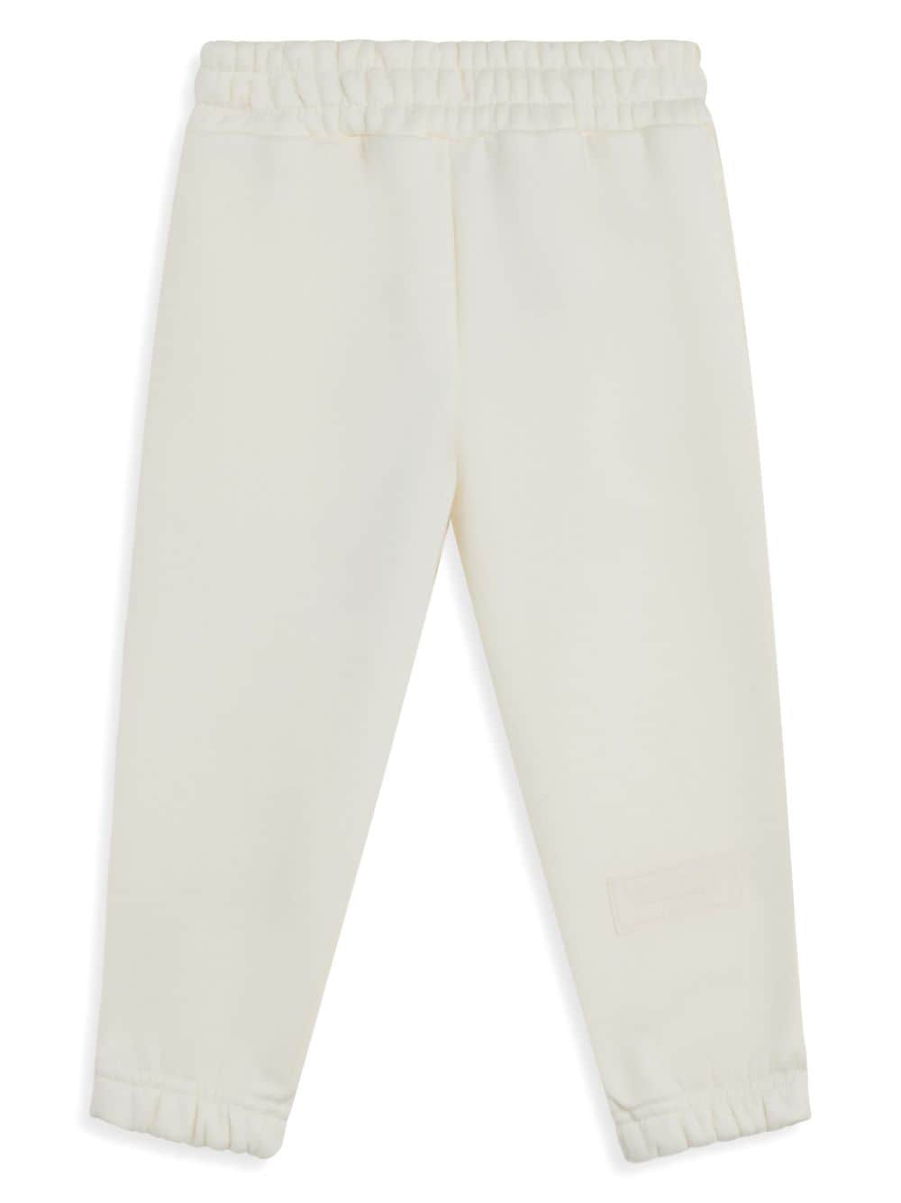 THE GIVING MOVEMENT logo-appliqué track trousers - Neutrals von THE GIVING MOVEMENT