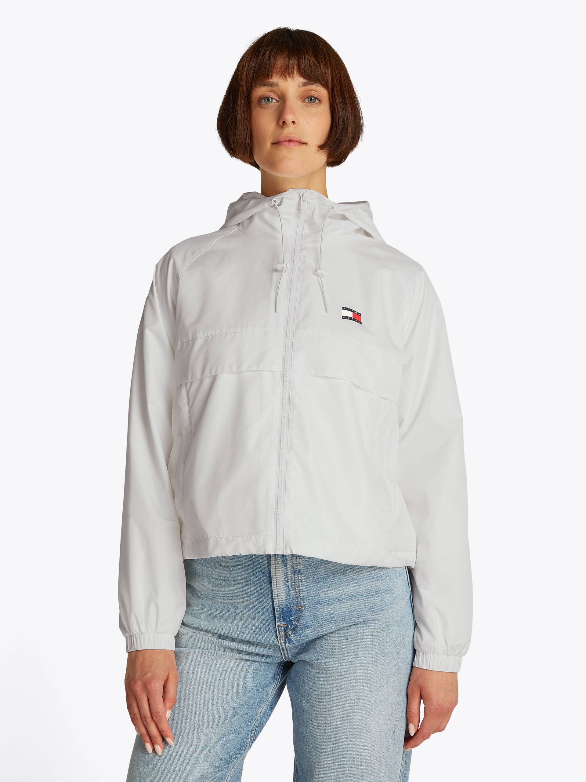 Tommy Jeans Windbreaker »TJW ESSENTIAL WINDBREAKER EXT«, mit Kapuze, mit Logodruck Tommy Jeans Windbreaker »TJW ESSENTIAL WINDBREAKER EXT«, mit Kapuze, mit Logodruck von TOMMY JEANS