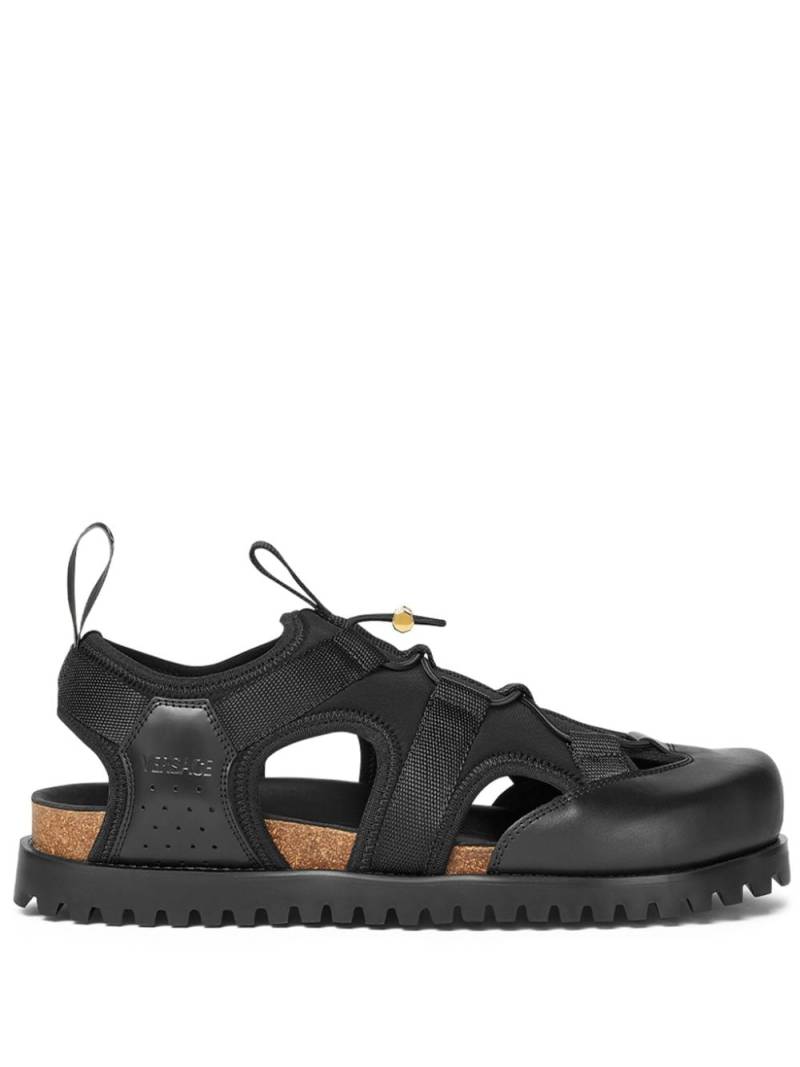 Versace logo-debossed caged sandals - Black von Versace